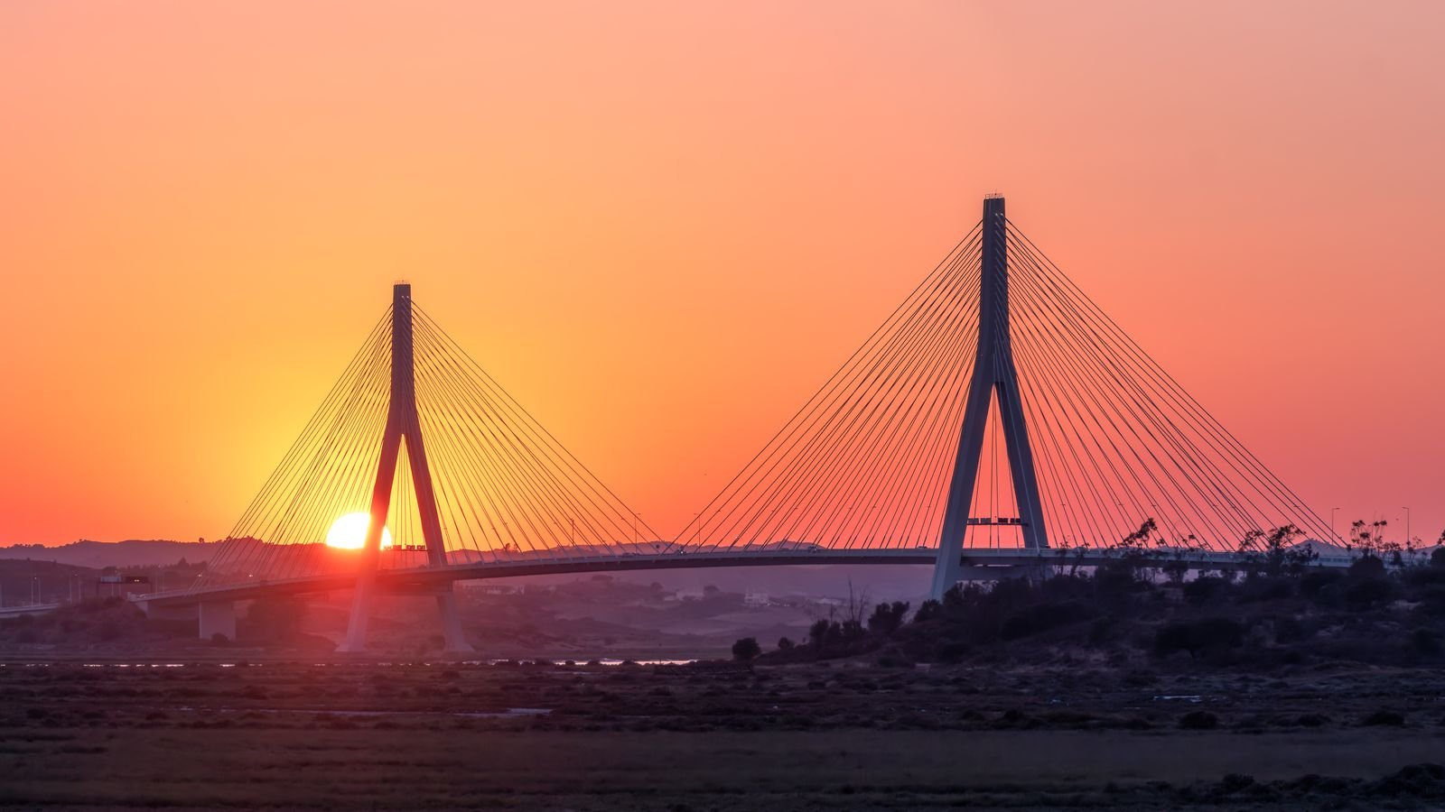 The international bridge over the Guadiana between Spain and Portugal at sunset